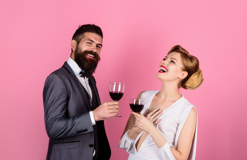 Couple smiling wiht a cup of wine
