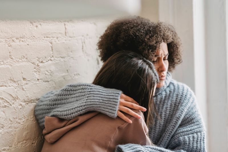Woman consoling friend in a toxic relationship