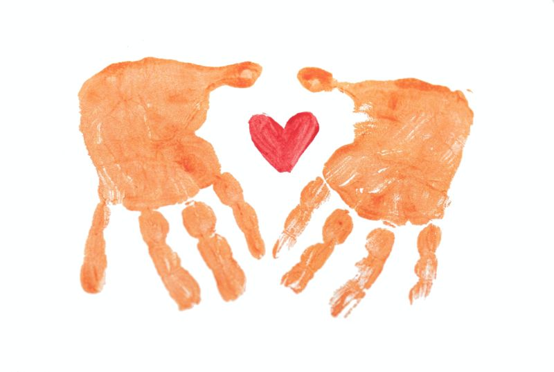 Fingerpaint hands around a heart